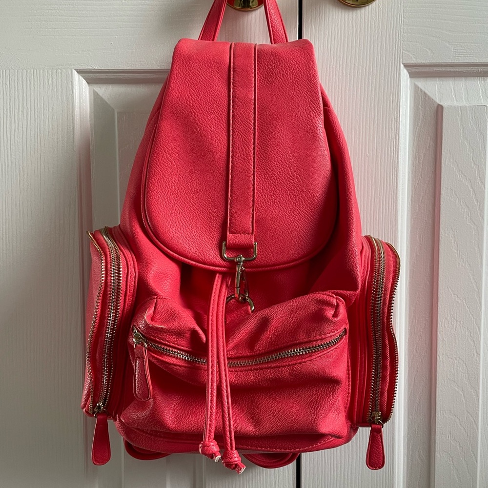 South moon under coral colored faux leather backpack